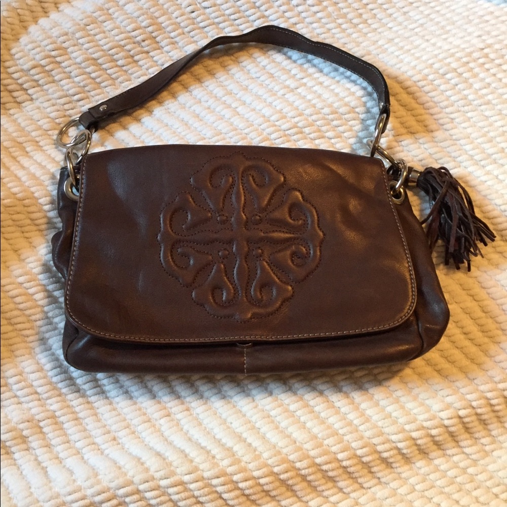Brown purse with beautiful polka dot interior.